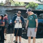 Hikers prepare for Acatenango Volcano hike with poles and gear.