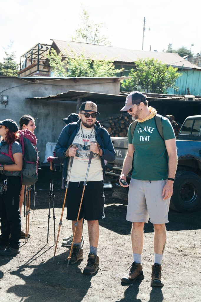 Hikers prepare for Acatenango Volcano hike with poles and gear.