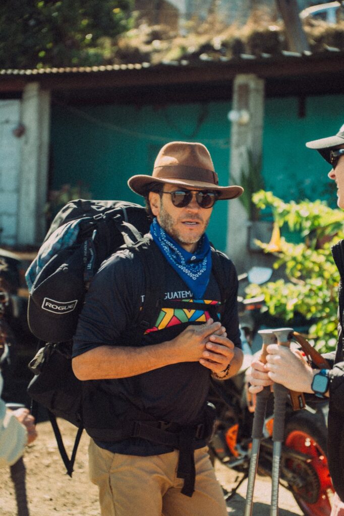 Man with backpack, hat, and "Guatemala" shirt on Acatenango Volcano hike.