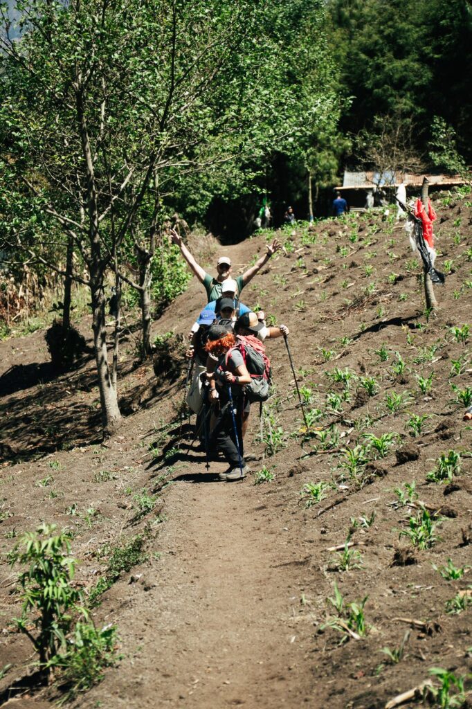 Hikers on Acatenango Volcano trail, one with arms raised