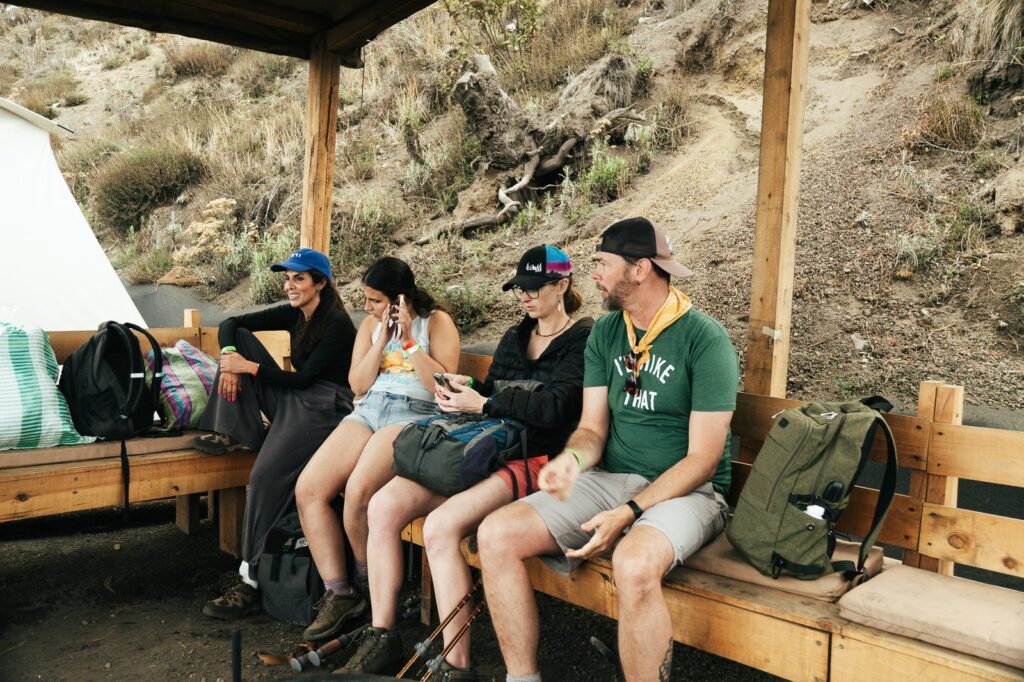 Hikers resting under shelter on Acatenango Volcano. Group of people taking a break during a volcano hike.